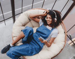 Person relaxed on a sofa enjoying entertainment as part of a balanced lifestyle