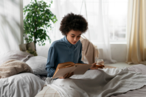 Person reading a book in a cozy setting with no phone in sight as a digital detox mental health