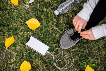 Smartphone placed face-down on a table with a nature scene through the window