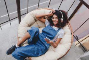 Person enjoying a creative hobby in a relaxed, happy state as a way of finding balance productivity rest play
