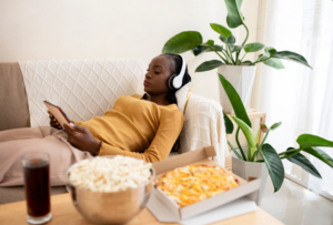 Person smiling while enjoying content in a relaxed environment as part of a mindful entertainment digital leisure routine